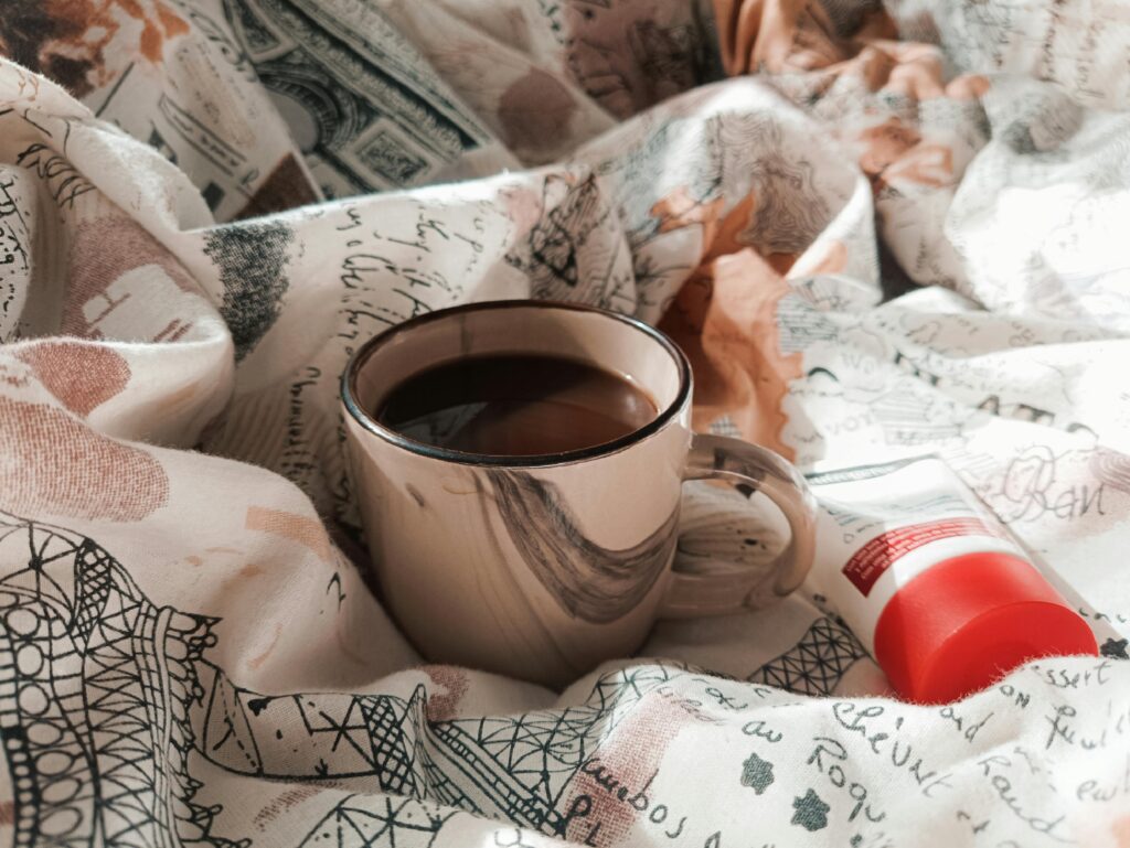 నవరాత్రి ఉపవాసంలో టీ, కాఫీ తాగవచ్చా? నిపుణుల సలహా||Can We Drink Tea and Coffee During Navratri Fasting? Expert Advice Current image: A comfortable setting featuring a steaming cup of coffee and skincare cream on patterned linens.