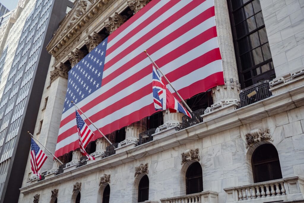 Current image: American flag on a historic building exterior symbolizing patriotism and national pride.